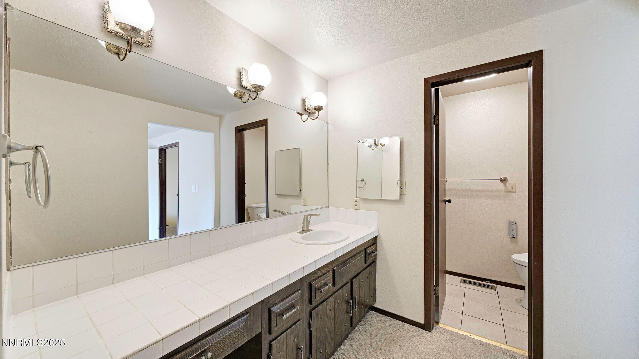 1515 Foster Drive Reno, NV 89509 - Photo 44 of 50 a bathroom with a double vanity sink and a mirror