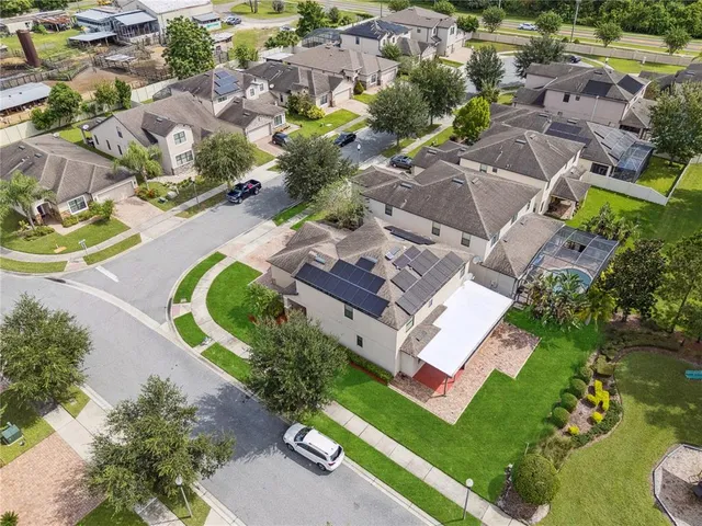 an aerial view of a house with a swimming pool yard and outdoor seating