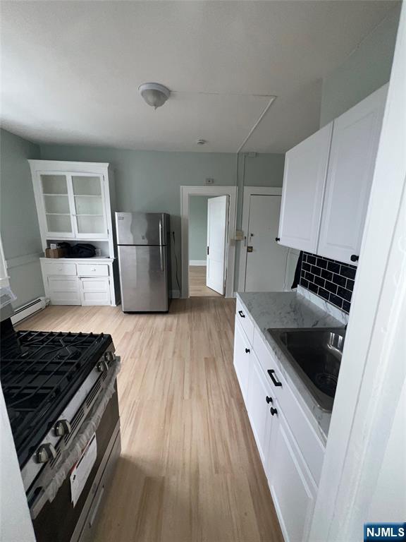 193 President Street, Unit 9 Passaic, NJ 07055 - Photo 11 of 11 a kitchen with granite countertop a stove and a refrigerator