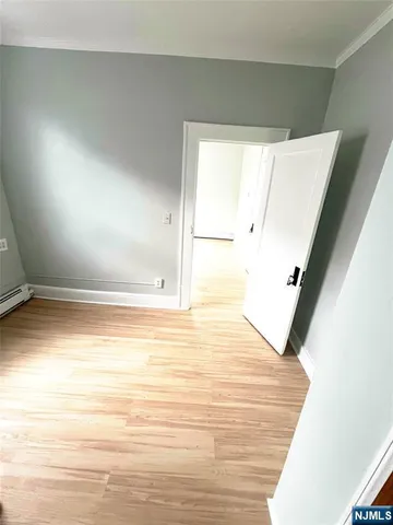 a view of a room with wooden floor