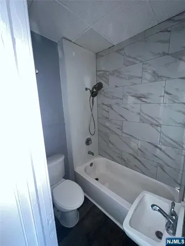 a bathroom with a toilet and a tub