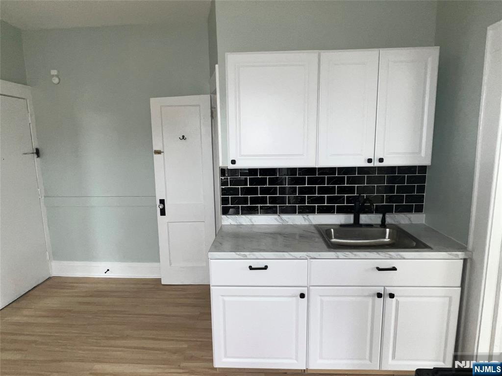 193 President Street, Unit 9 Passaic, NJ 07055 - Photo 8 of 11 a view of kitchen with granite countertop a sink