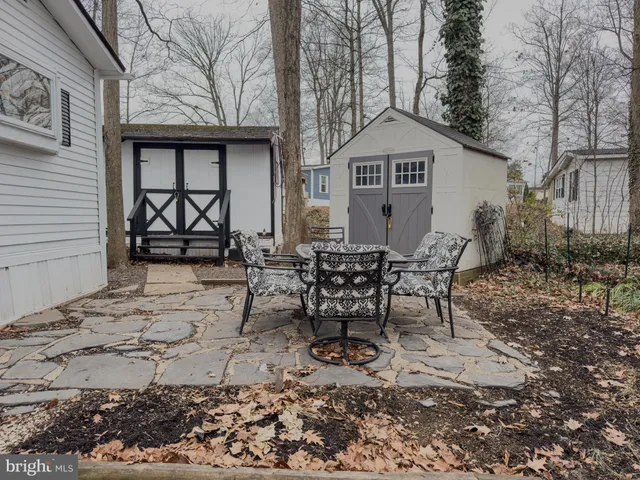 a view of a chairs and table in backyard