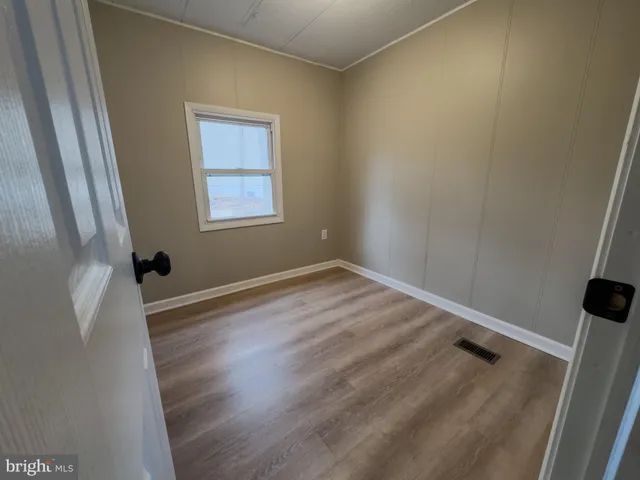a view of a room with wooden floor and small space