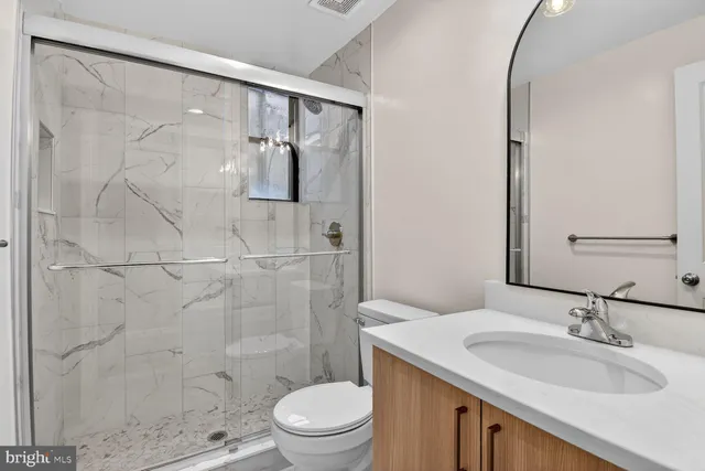 a bathroom with a sink toilet and shower