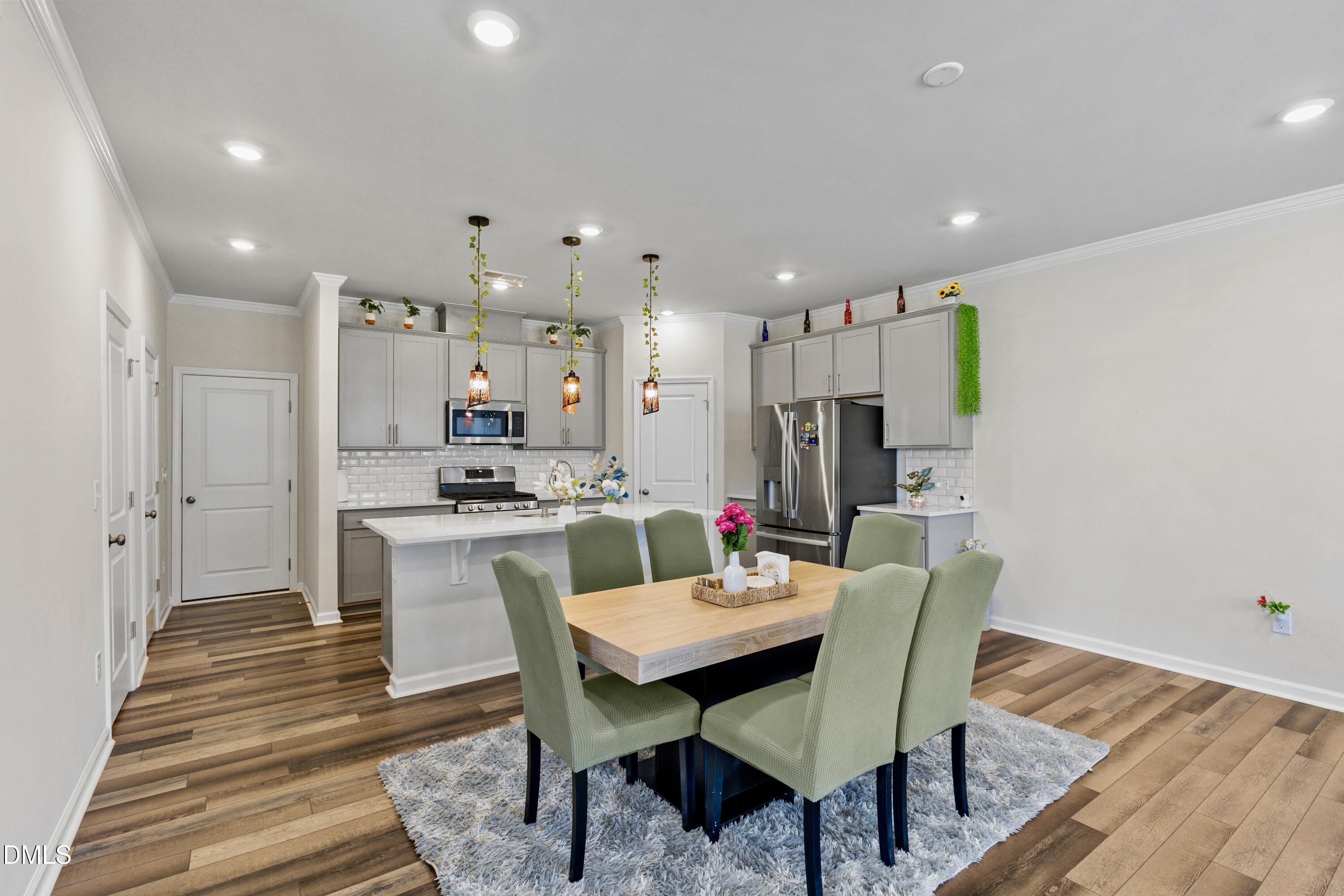 1811 Aspen River Lane Apex, NC 27502 - Photo 15 of 53 a view of a dining room with furniture