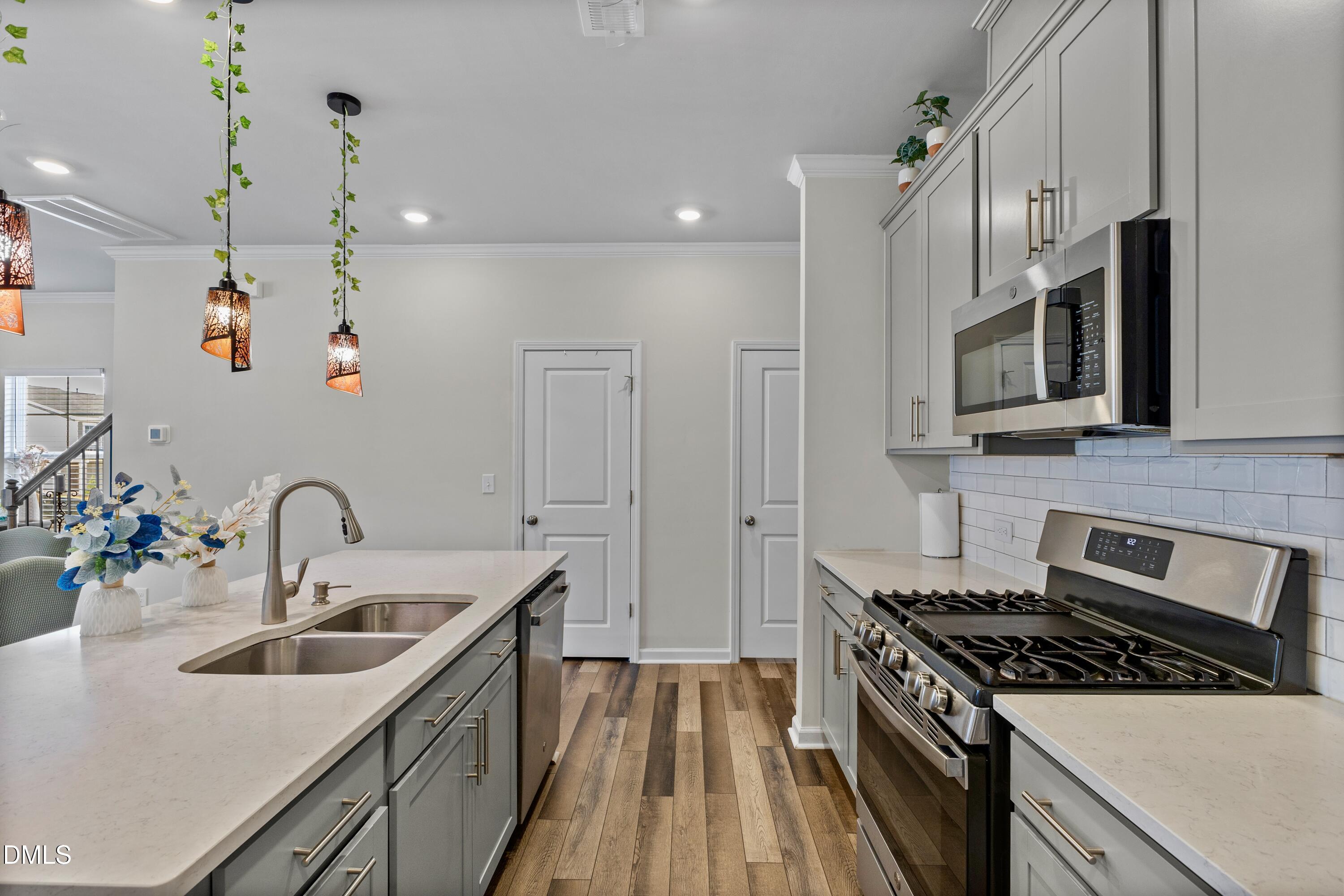 1811 Aspen River Lane Apex, NC 27502 - Photo 17 of 53 a kitchen with stainless steel appliances granite countertop a sink stove and refrigerator