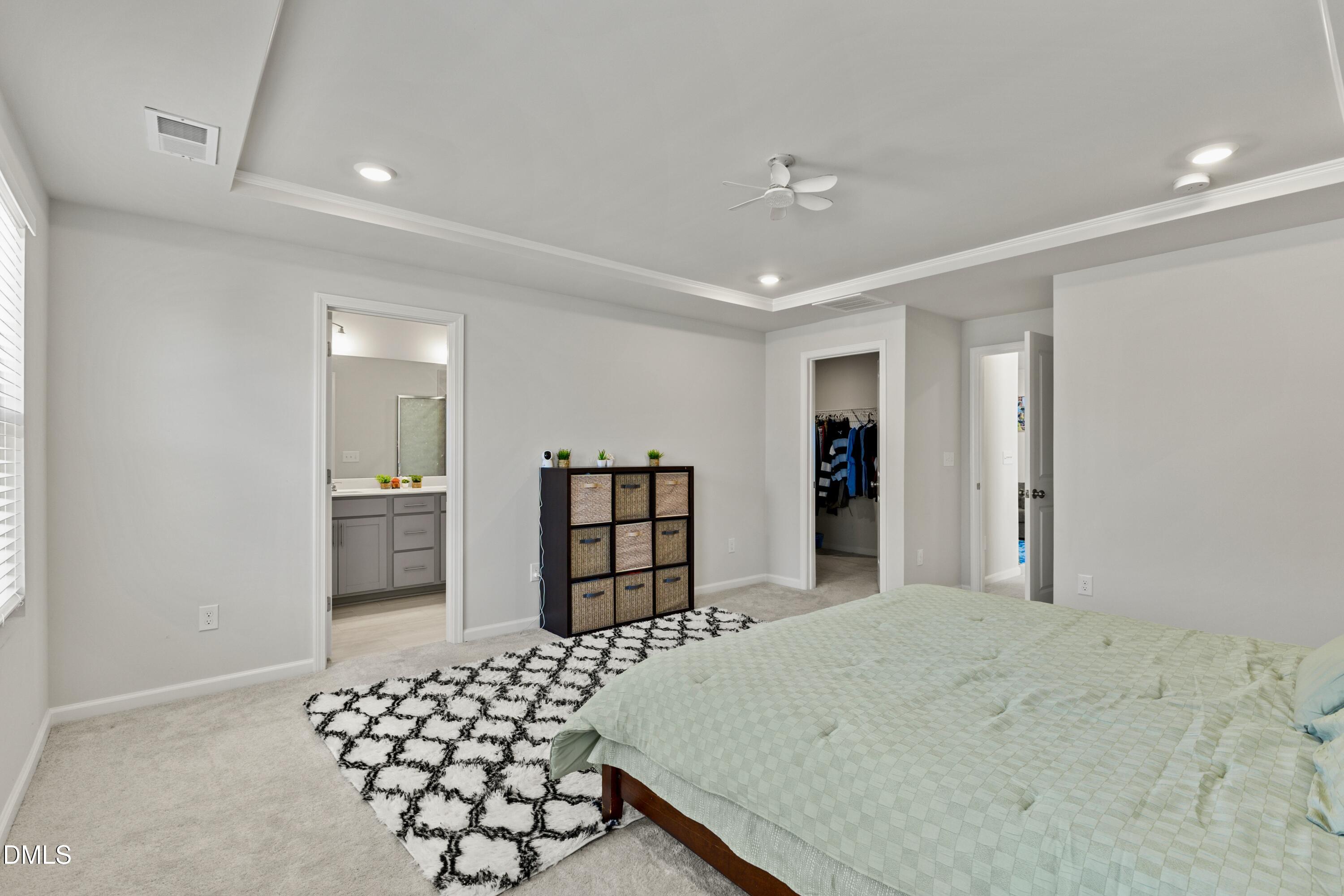 1811 Aspen River Lane Apex, NC 27502 - Photo 25 of 53 a bedroom with a bed and cabinets