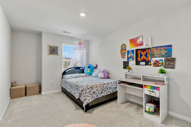 a bedroom with a bed and a desk