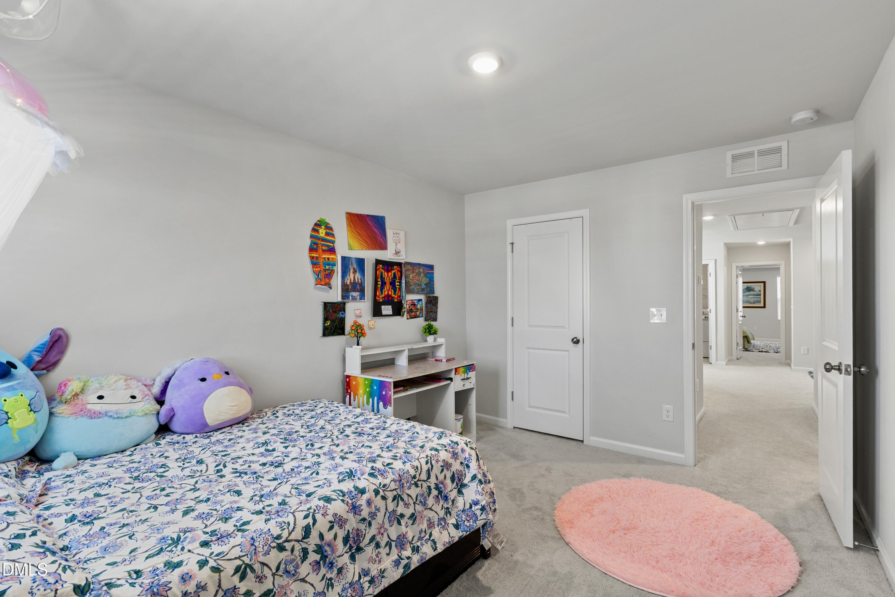 1811 Aspen River Lane Apex, NC 27502 - Photo 28 of 53 a bedroom with a bed and a desk