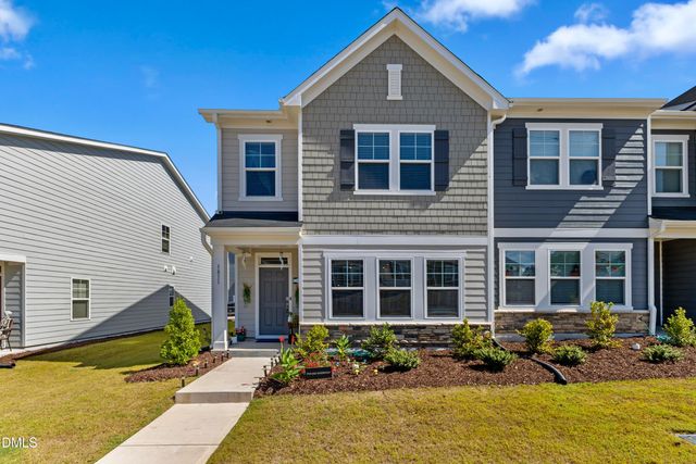 a front view of a house with lots of small garden