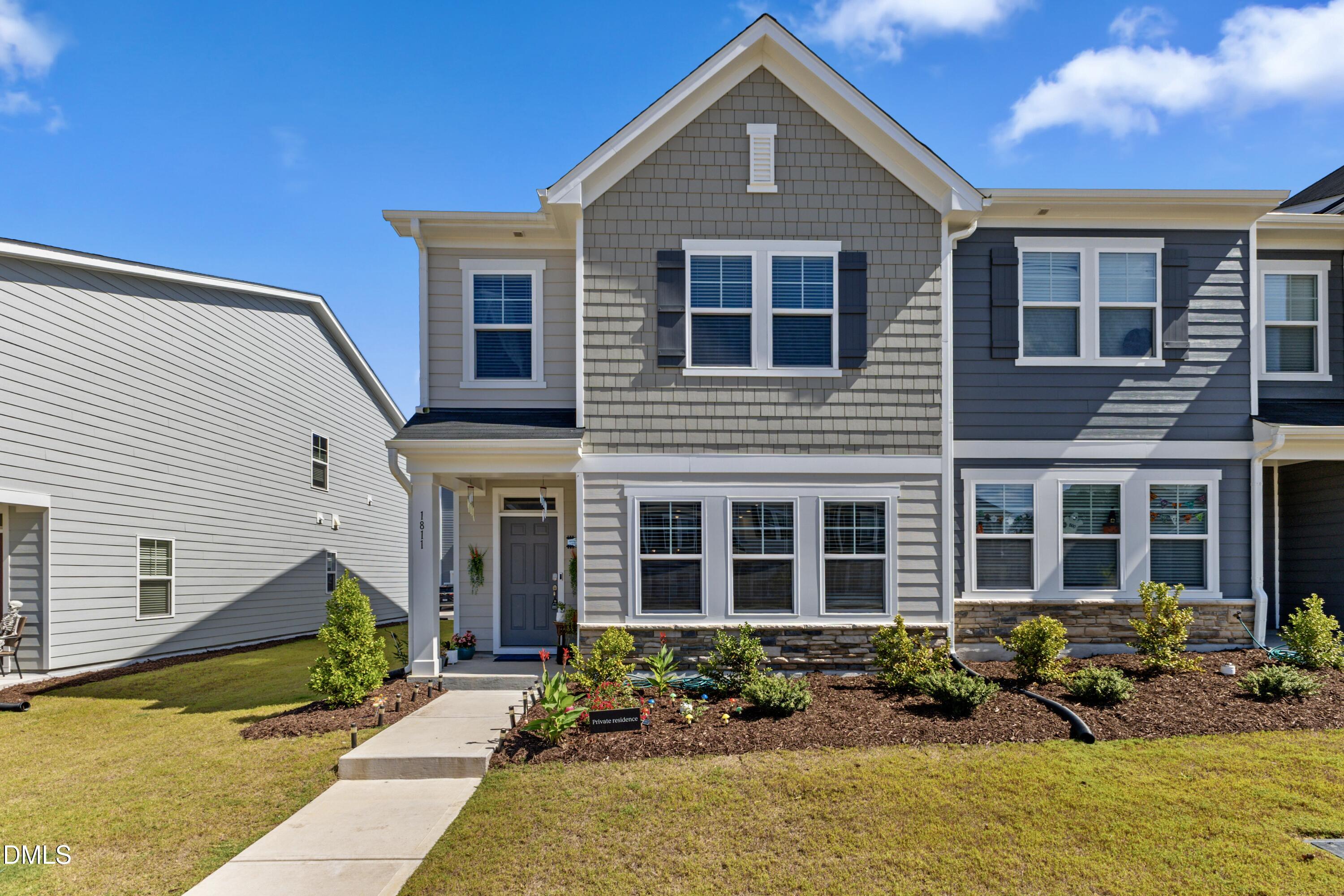 1811 Aspen River Lane Apex, NC 27502 - Photo 3 of 53 a front view of a house with lots of small garden