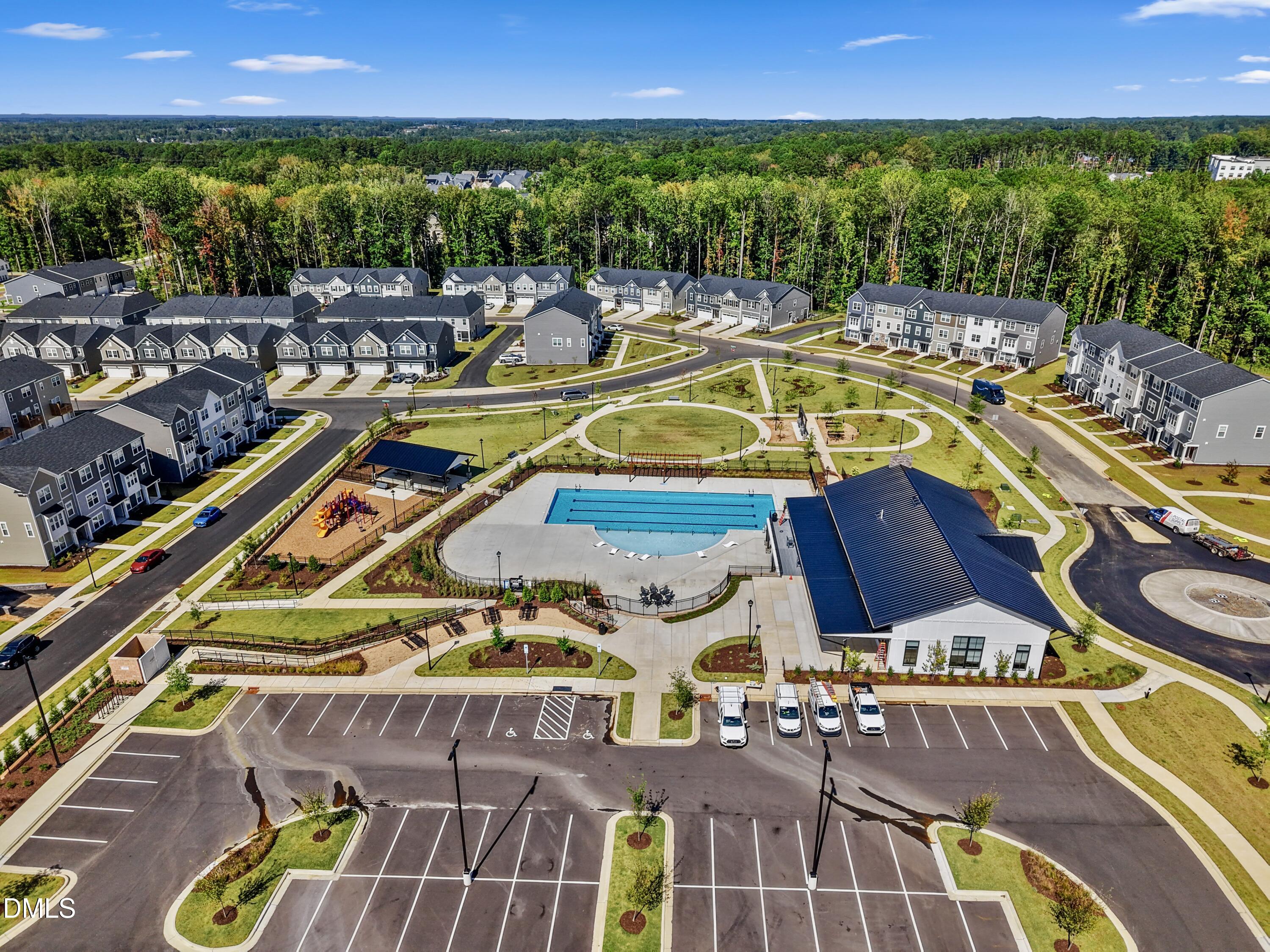 1811 Aspen River Lane Apex, NC 27502 - Photo 35 of 53 a view of a swimming pool with seating area and trees in the background