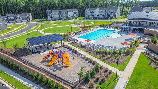 a view of a swimming pool with a patio and a yard