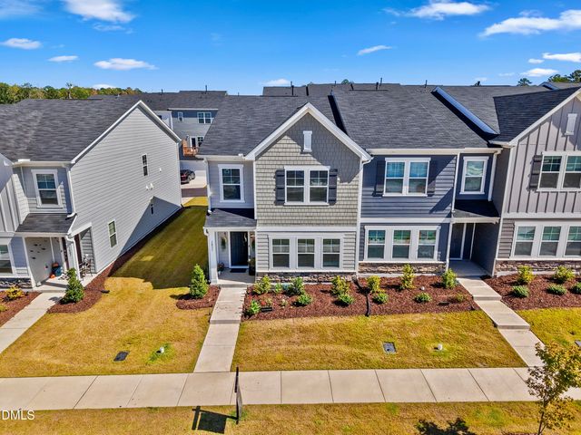 a view of a white house with a large pool