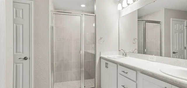 a bathroom with a double vanity sink and mirror