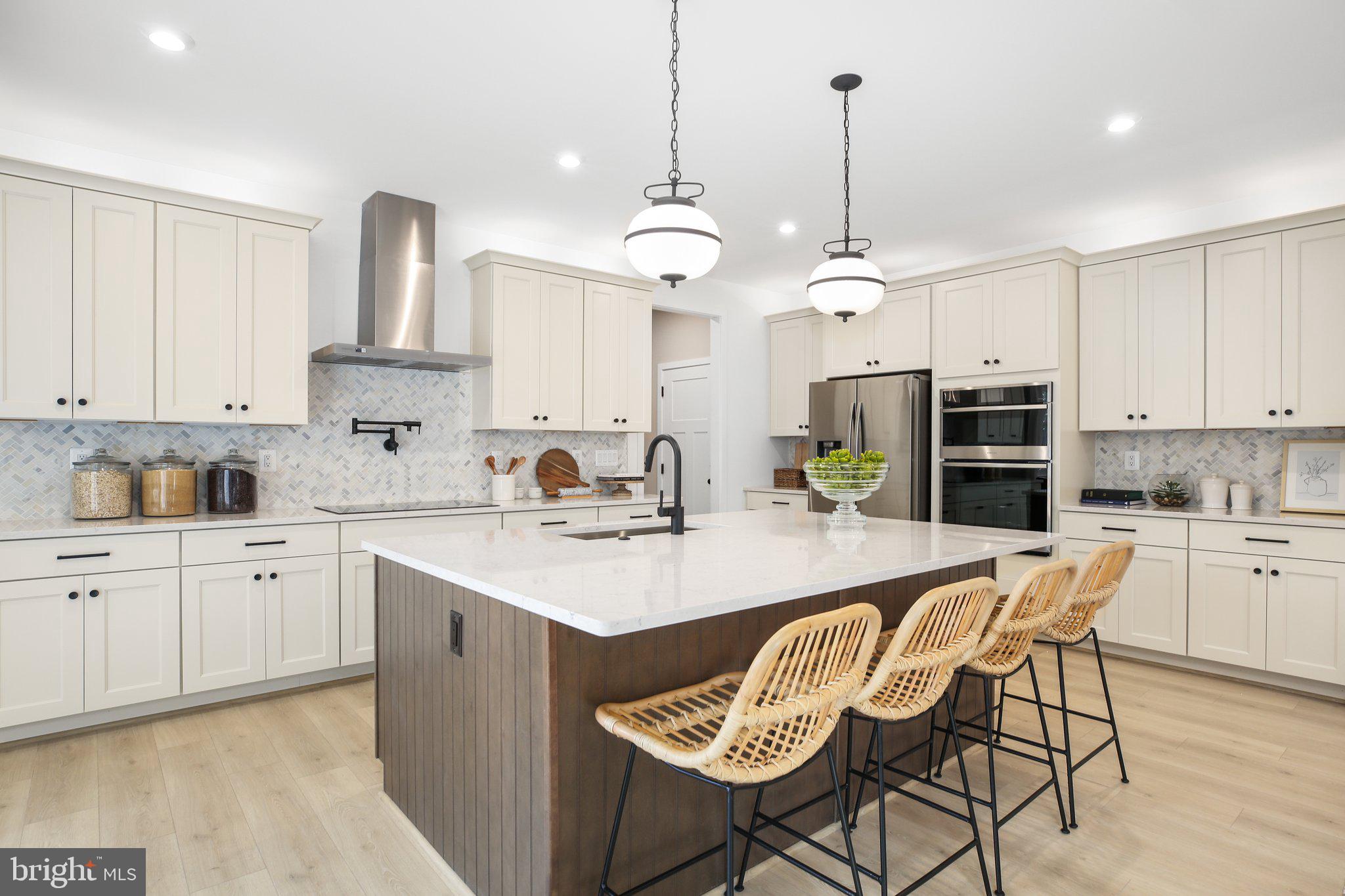 2 Spotswood Furnace Road Fredericksburg, VA 22407 - Photo 12 of 43 a kitchen with stainless steel appliances kitchen island granite countertop a sink a stove a dining table and chairs
