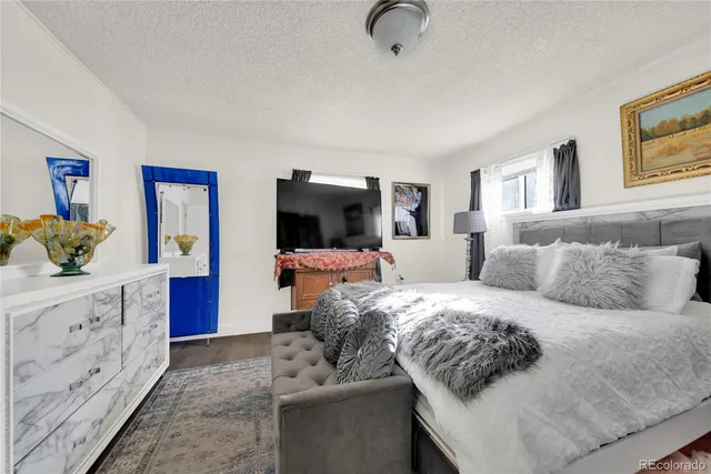 a living room with furniture and a dresser