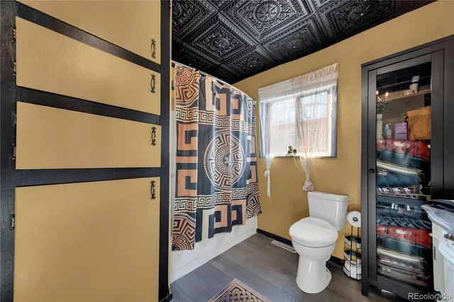 a bathroom with a toilet and a shower