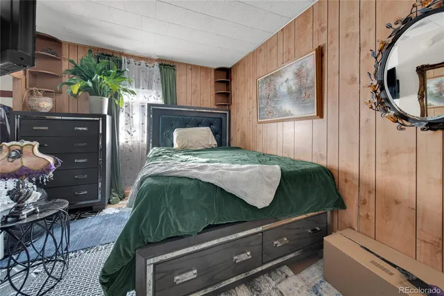 a bedroom with a bed and a mirror on dresser