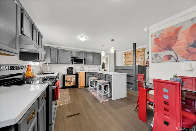 a kitchen with stainless steel appliances a stove a sink and a refrigerator