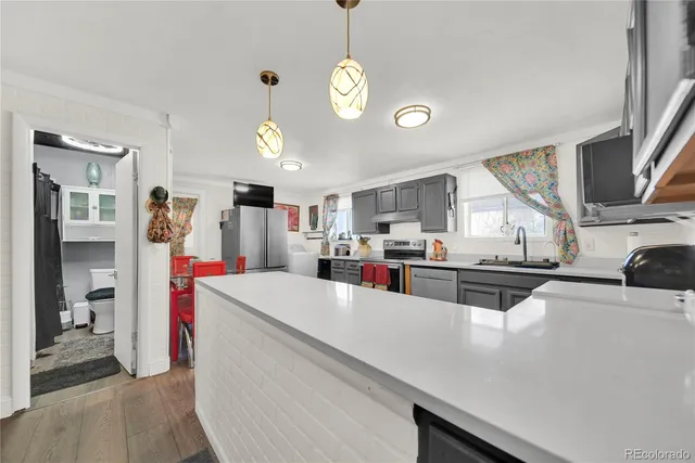 a living room with stainless steel appliances kitchen island granite countertop furniture and a kitchen view