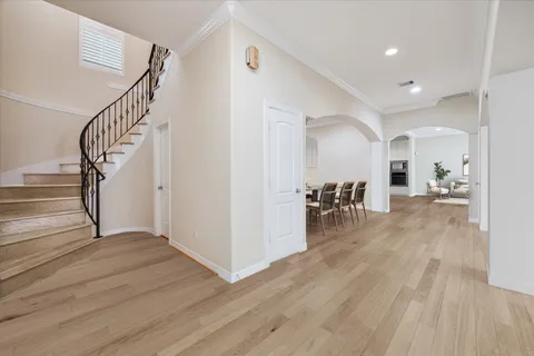 a view of dining room with wooden floor and stairs