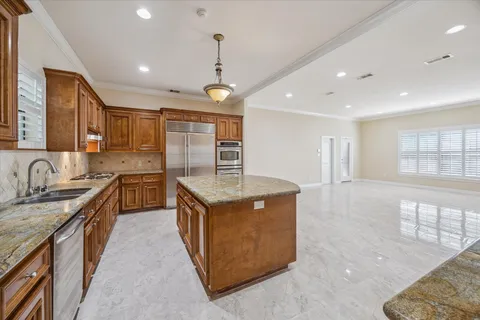 a kitchen with stainless steel appliances granite countertop a sink stove and refrigerator