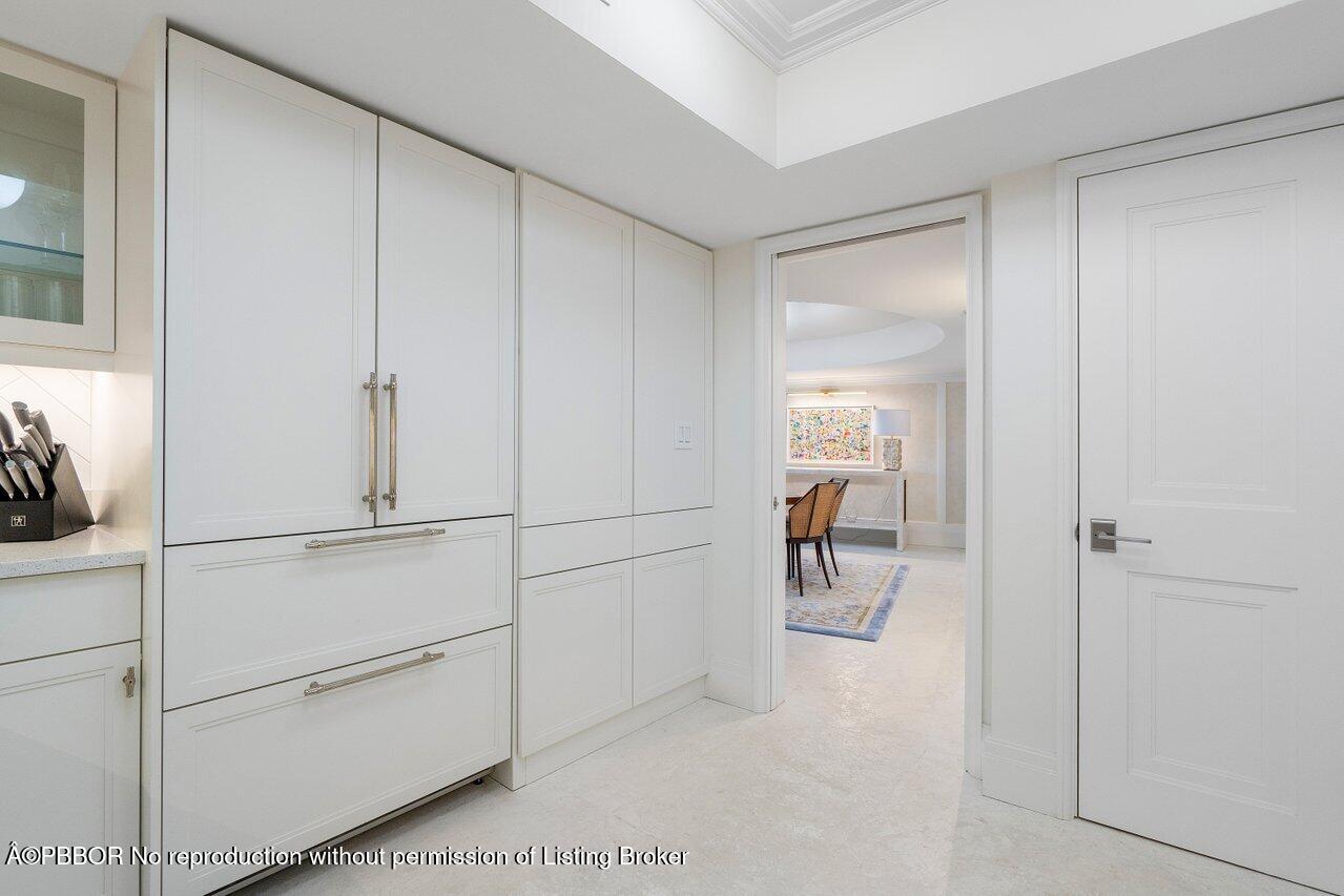 130 Sunrise Avenue, Unit 616 Palm Beach, FL 33480 - Photo 12 of 34 a hallway with white doors and chandelier