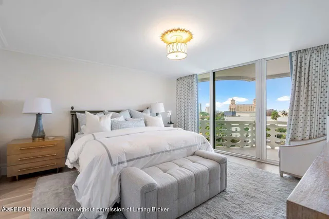 a bedroom with a bed and a lamp next to a window