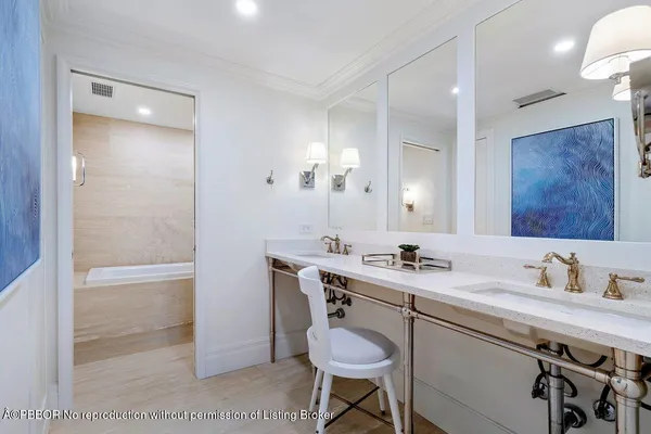 a bathroom with a sink a toilet a mirror and shower