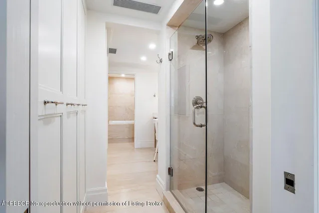 a bathroom with a shower and a glass door