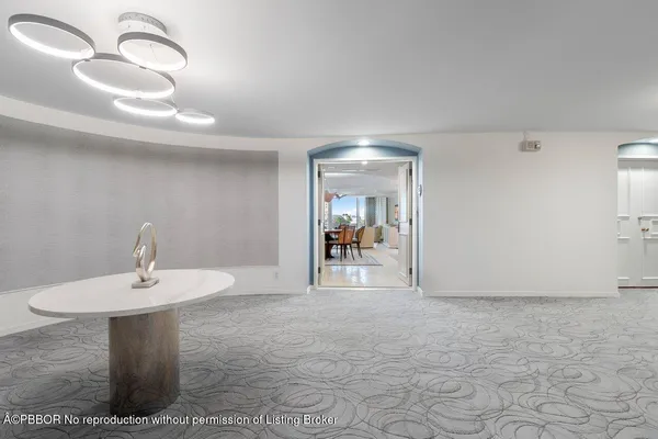 a view of a hallway with entryway dining table and chairs