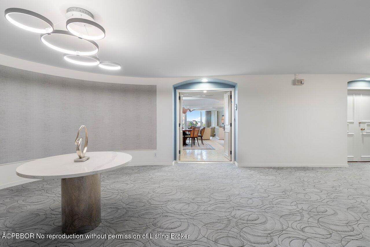 130 Sunrise Avenue, Unit 616 Palm Beach, FL 33480 - Photo 22 of 34 a view of a hallway with entryway dining table and chairs