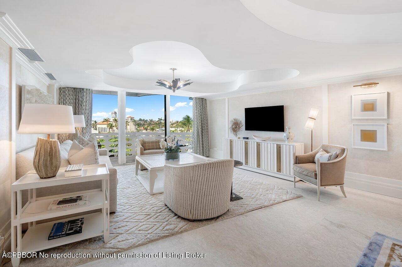 130 Sunrise Avenue, Unit 616 Palm Beach, FL 33480 - Photo 4 of 34 a living room with furniture and flat screen tv