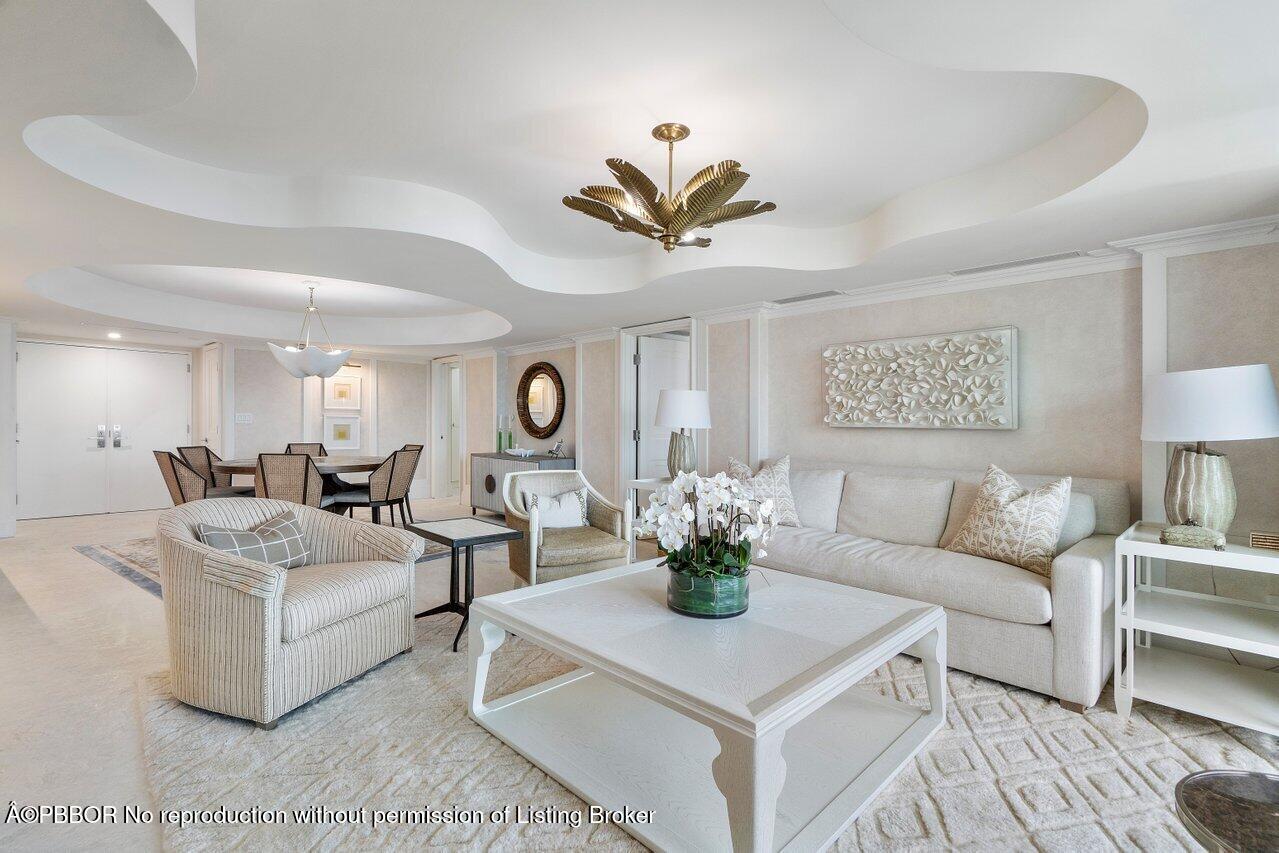 130 Sunrise Avenue, Unit 616 Palm Beach, FL 33480 - Photo 6 of 34 a living room with furniture a chandelier and a potted plant