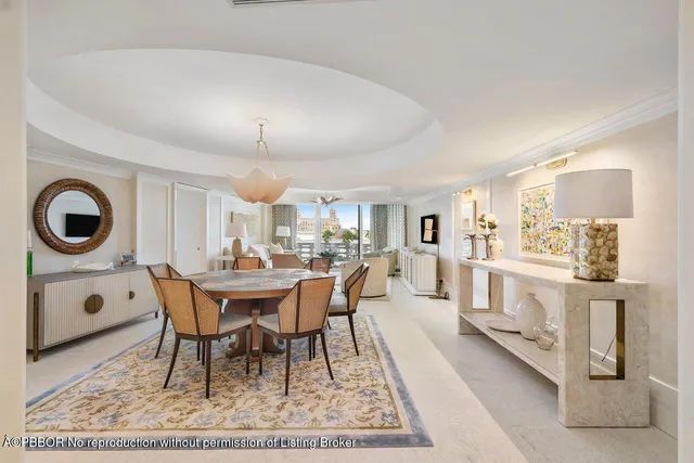 a view of a dining room with furniture and chandelier
