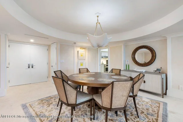 a dining room with furniture and a mirror