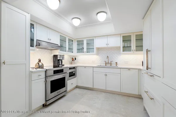 a kitchen with granite countertop cabinets stainless steel appliances and sink