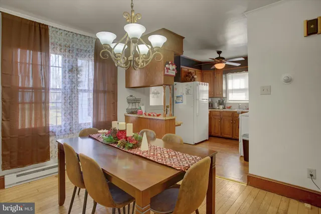 a dining room with furniture and chandelier