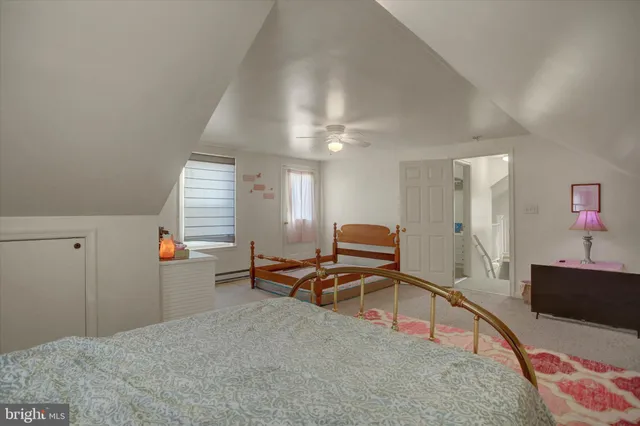 a bedroom with a bed and a wooden floor