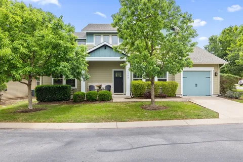 a house that has a tree in front of it