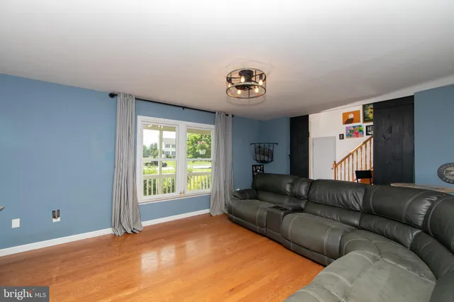 a living room with furniture a flat screen tv and a couch