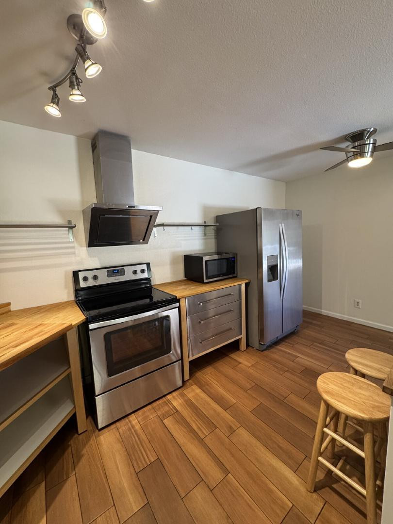 5525 East Thomas Road, Unit F1 Phoenix, AZ 85018 - Photo 3 of 14 a kitchen with stainless steel appliances a stove a microwave and a refrigerator