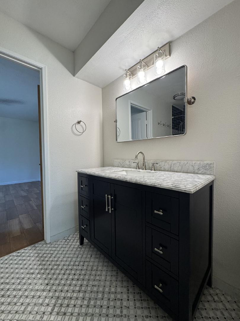 5525 East Thomas Road, Unit F1 Phoenix, AZ 85018 - Photo 9 of 14 a bathroom with a sink vanity and mirror