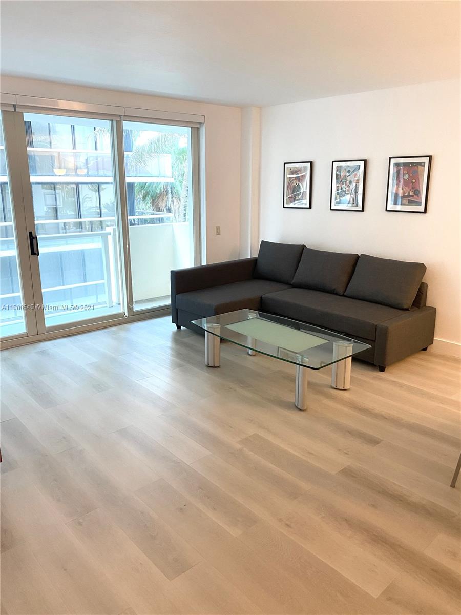 a living room with furniture and large window