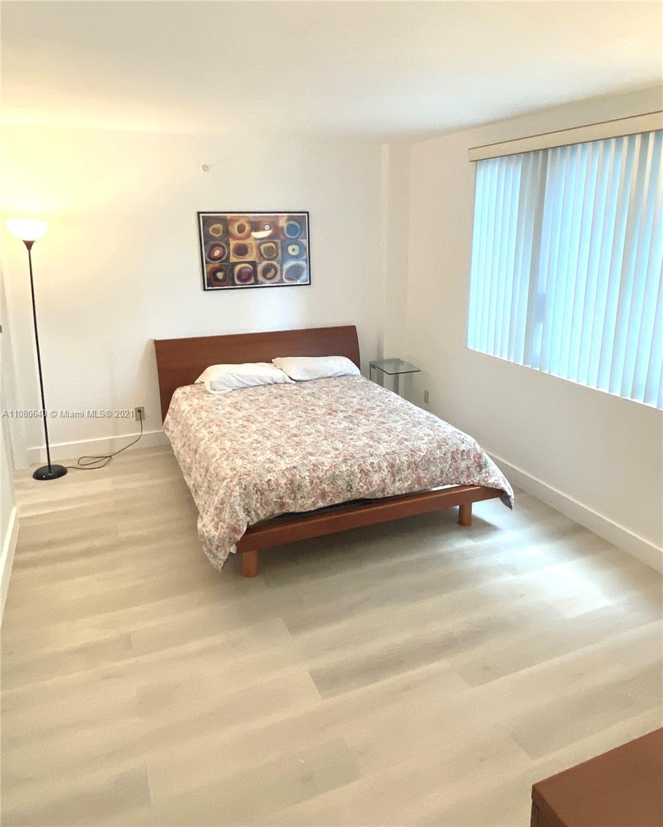 9499 Collins Avenue, Unit 309 Surfside, FL 33154 - Photo 14 of 16 a bedroom with a bed and a window