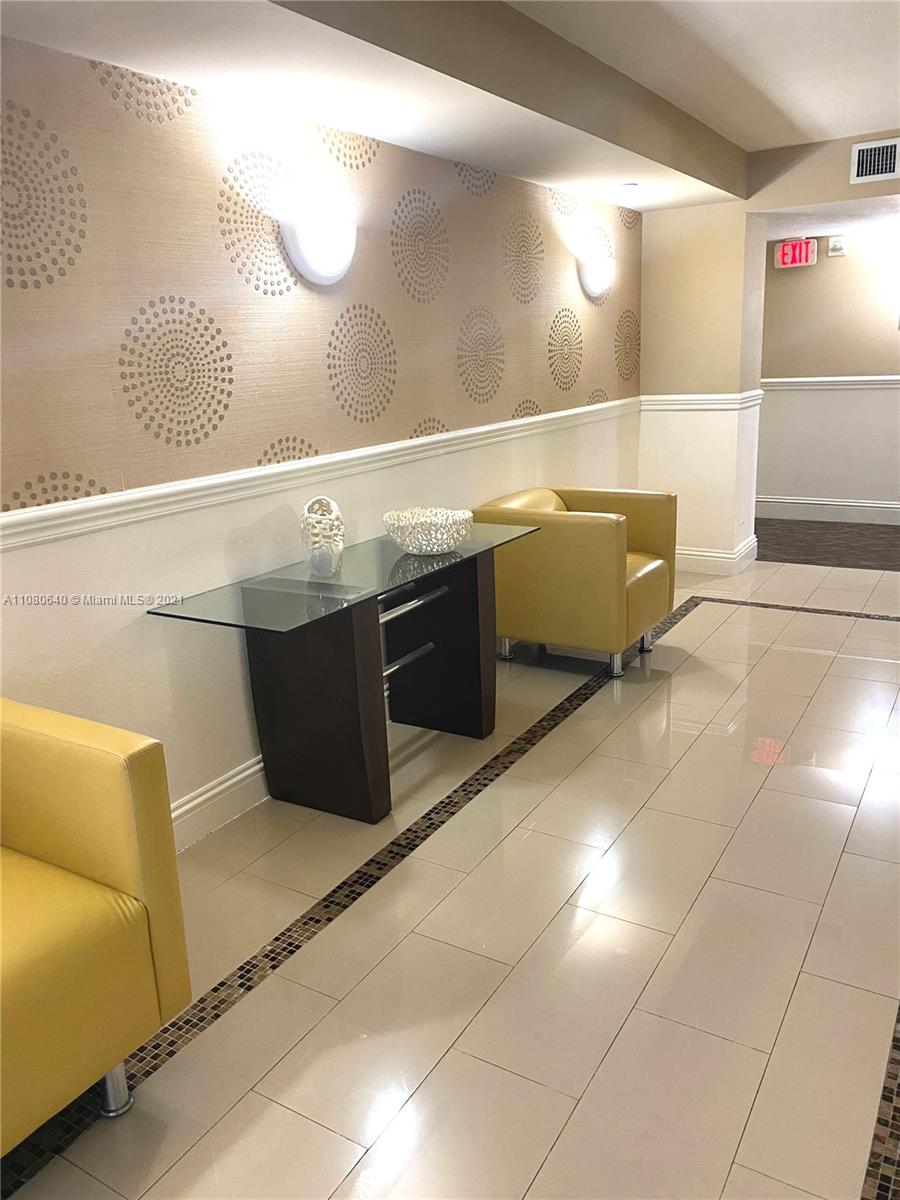 9499 Collins Avenue, Unit 309 Surfside, FL 33154 - Photo 16 of 16 a kitchen with kitchen island granite countertop a sink and cabinets