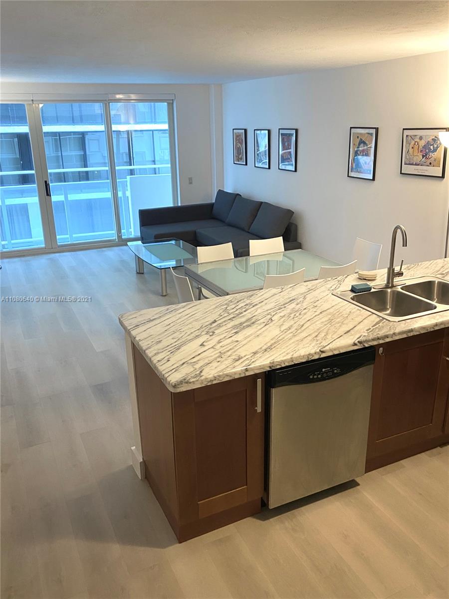 9499 Collins Avenue, Unit 309 Surfside, FL 33154 - Photo 5 of 16 a living room with granite countertop furniture and dresser