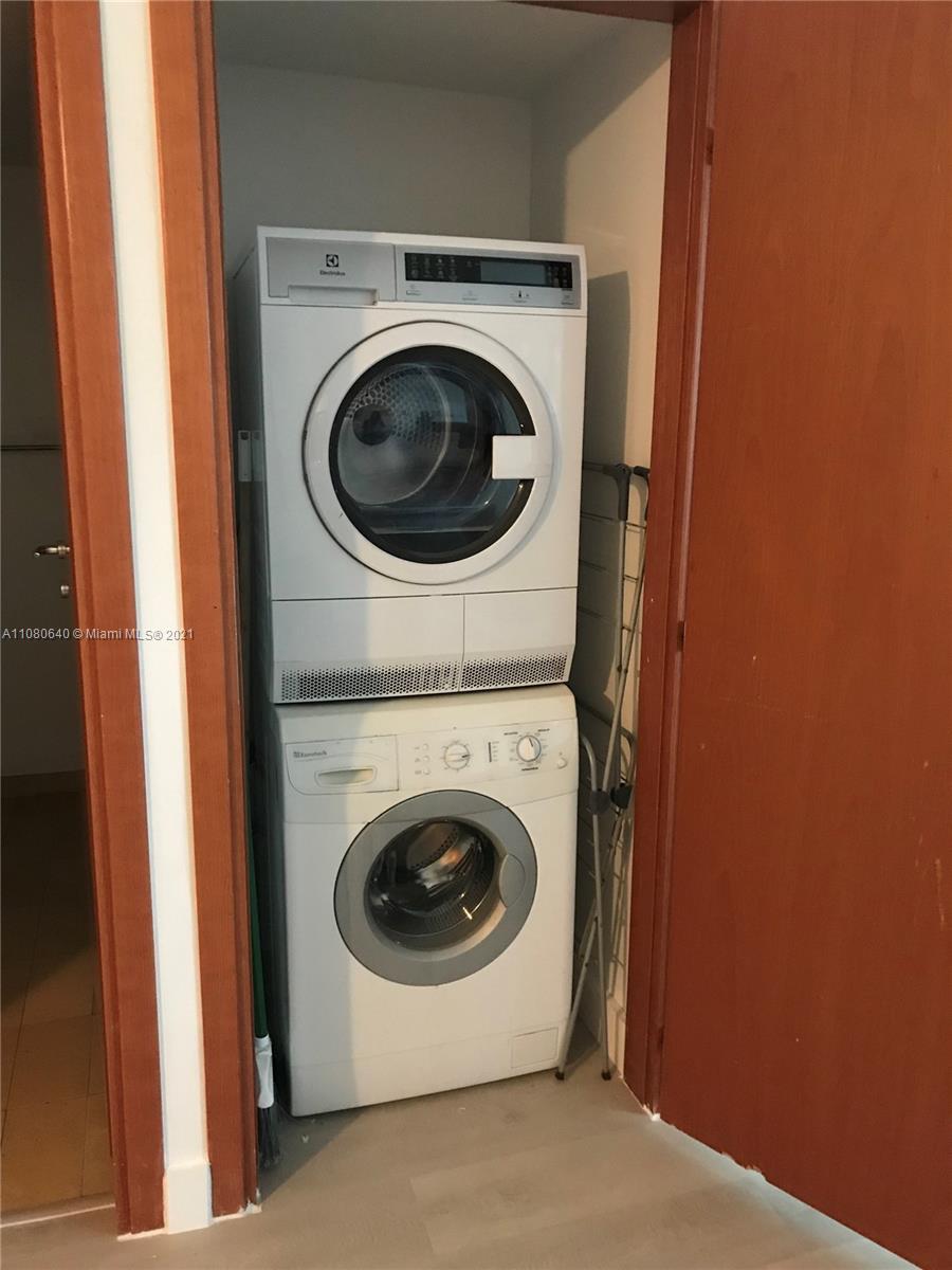 9499 Collins Avenue, Unit 309 Surfside, FL 33154 - Photo 8 of 16 a utility room with dryer and washer